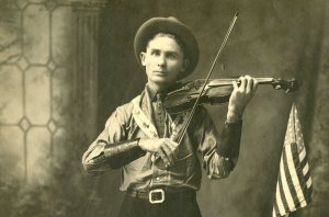 Eck Robertson holding his fiddle